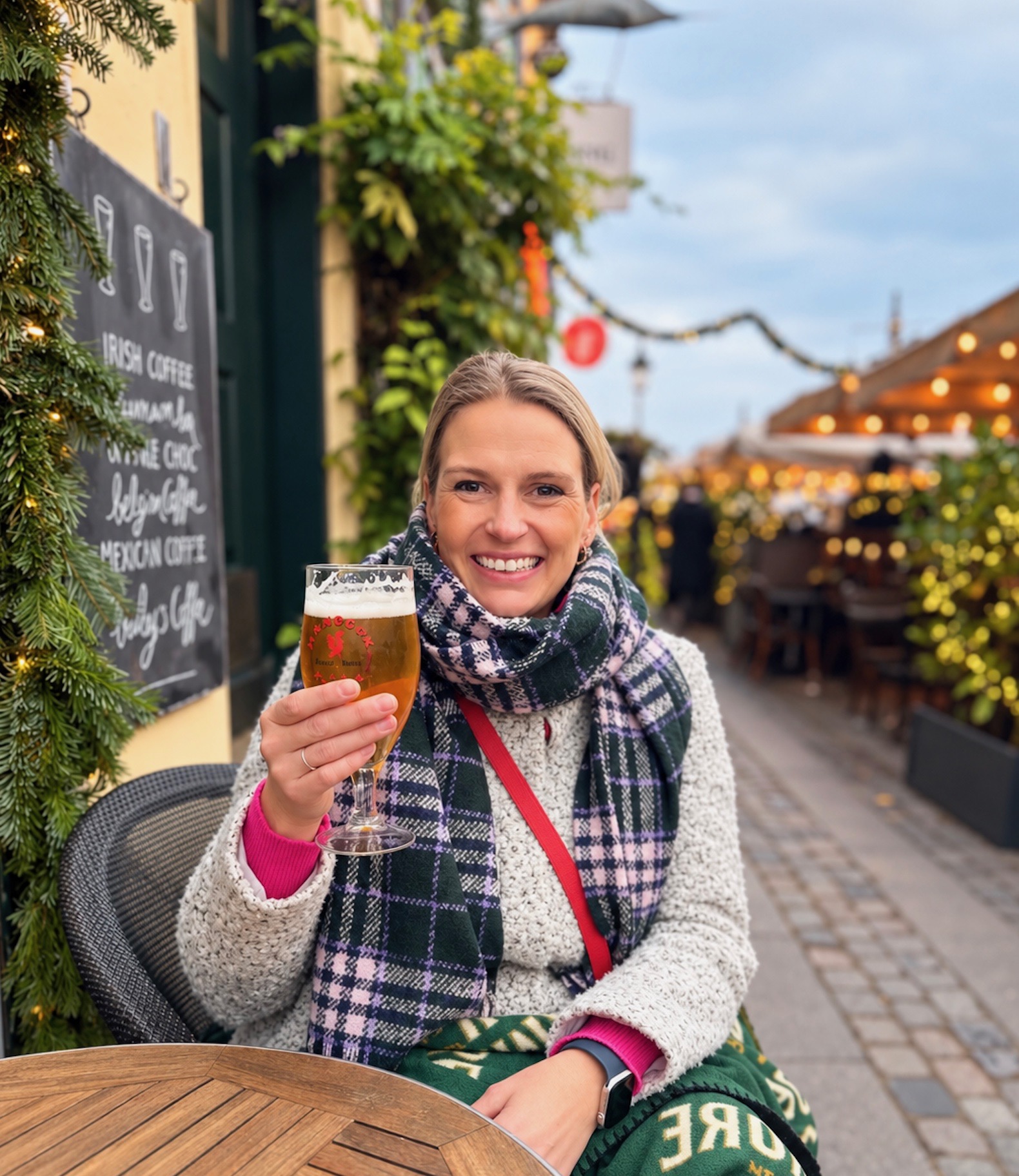 Jess enjoying a drink at an outdoor café
